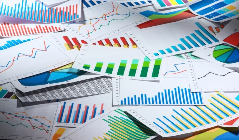 Business graphs and charts on table